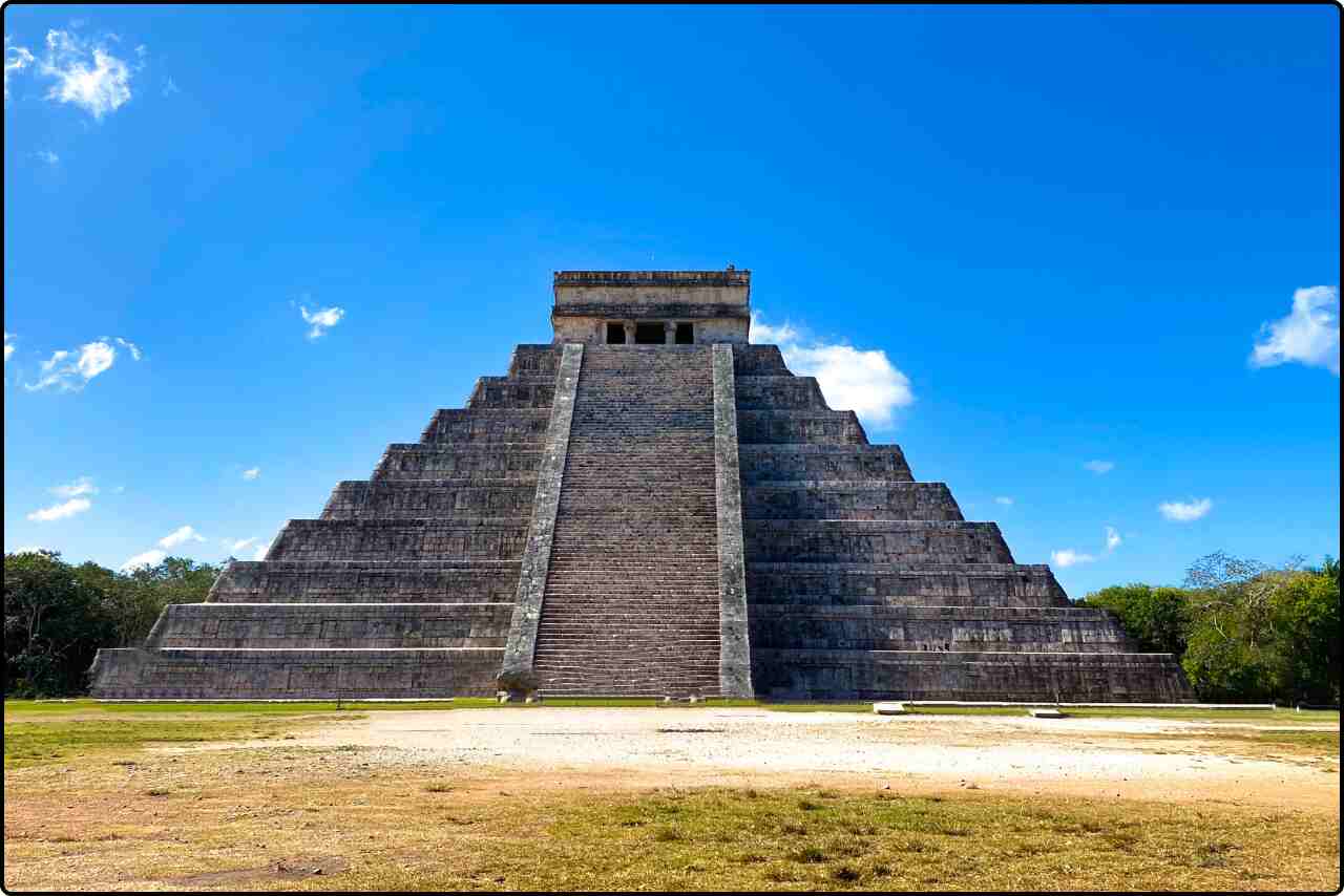 Chichen Itza pyramid, known as El Castillo, standing tall under a clear blue sky.